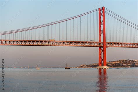 25 de Abril bridge tower in afternoon with calm sea Stock Photo | Adobe ...