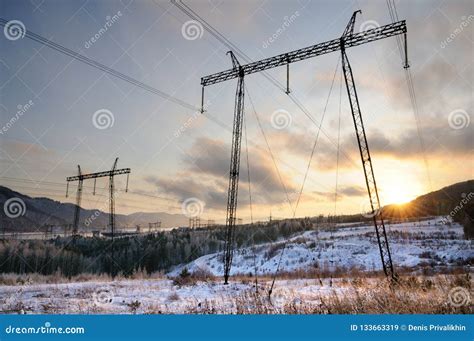 Silhouettes of Electricity Pylons during a Winter Sunset Stock Image ...