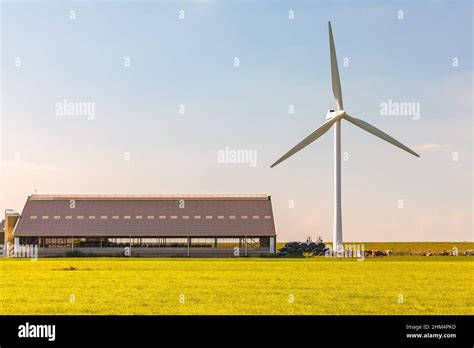 Dutch modern farmhouse with wind turbine Stock Photo - Alamy