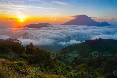 Golden sunrise mountain peak with sea of clouds. Perfect for nature ...