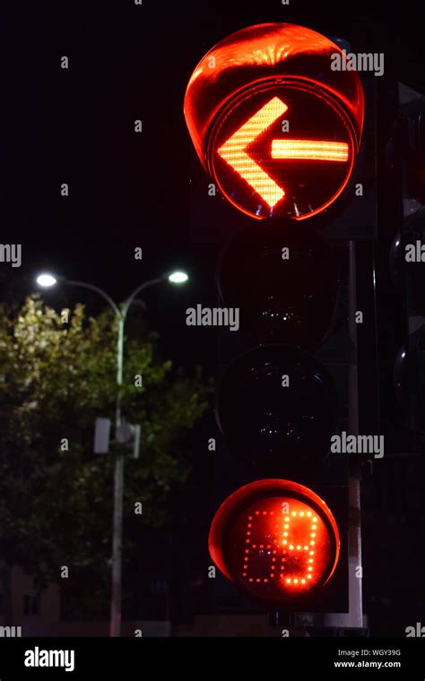 Red left turn arrow of a traffic light Stock Photo - Alamy