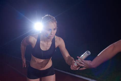 athletic runners passing baton in relay race 12651062 Stock Photo at ...