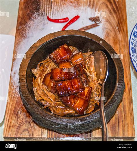 Pork belly braised in dark soy sauce and served in clay pot Stock Photo ...