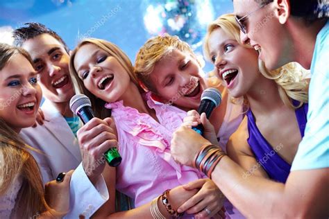 Friends singing at party — Stock Photo © pressmaster #47818953