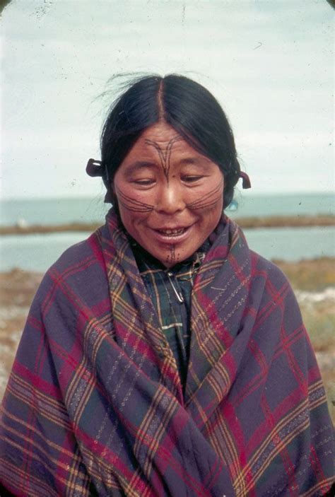 an old woman with her eyes closed standing in front of the ocean ...