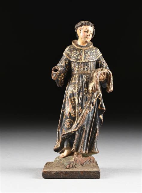 A SPANISH COLONIAL POLYCHROME AND CARVED WOOD SANTO FIGURE O