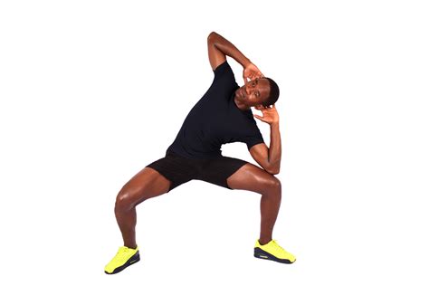 Athletic man doing squats with side bend