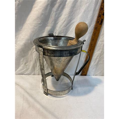 Vintage cone strainer with wood pestle