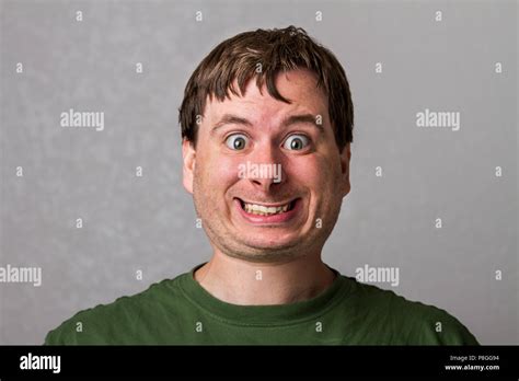 Guy making a creepy smile with a nice distorted head Stock Photo - Alamy