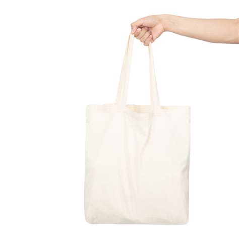 Hand holding canvas tote bag mockup 8520848 PNG