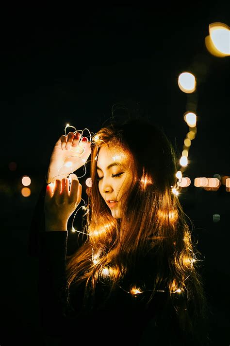 Royalty-Free photo: Woman holding string lights during night time | PickPik