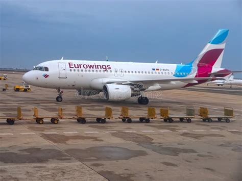 Eurowings Airplane with Empty Luggage Trolleys at the Airport Editorial Stock Image - Image of ...