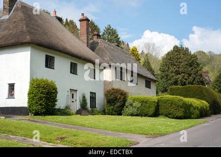 The picturesque thatched roof cottages of Milton Abbas Village Dorset ...