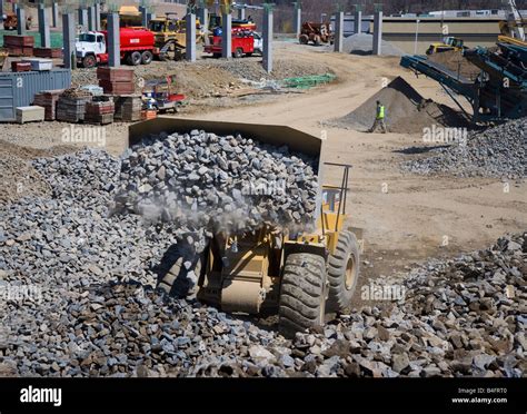 Bulldozer dumping rocks Stock Photo - Alamy