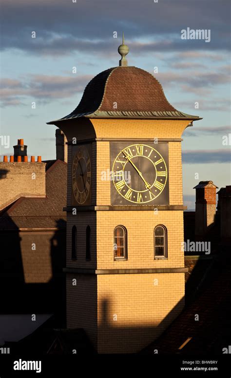 Swiss clock tower with golden glow taken in the golden hour, Neuchatel Switzerland by Charles ...