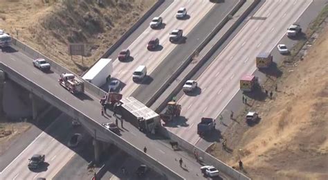 Truck crash spills cattle off of overpass onto I-15 below