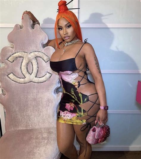 Woman with Orange Hair Poses with Chanel Bag and Purse