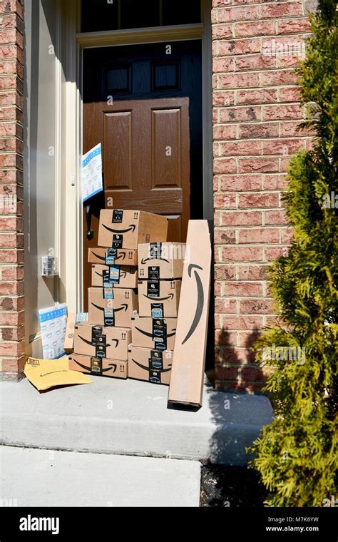 Amazon Prime boxes delivered and stacked at the front door of a residential home, USA Stock ...