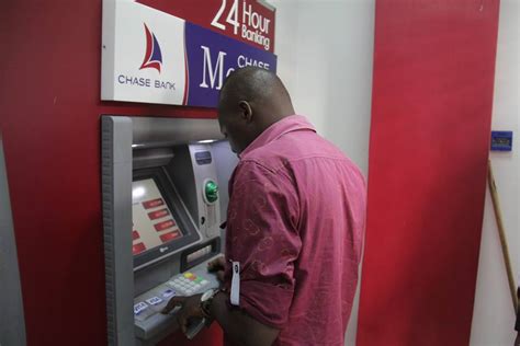 PHOTOS: Chase Bank Customers Flock The ATMs As Bank Re-Opens