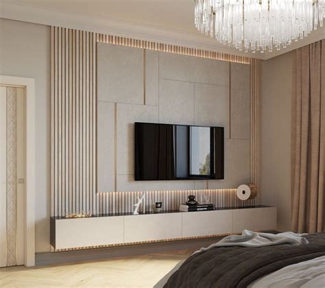 a bedroom with a bed, television and chandelier