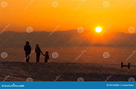 Young Family with Child , Holding Hands, Watching Sunset, Winter. Stock ...