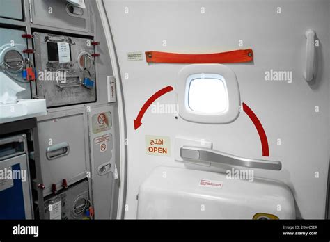 Emergency exit door in an airplane Stock Photo - Alamy