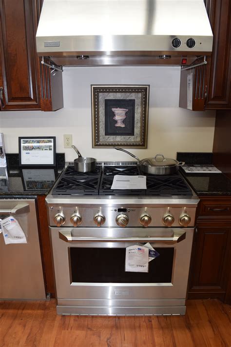 a stove top oven sitting inside of a kitchen