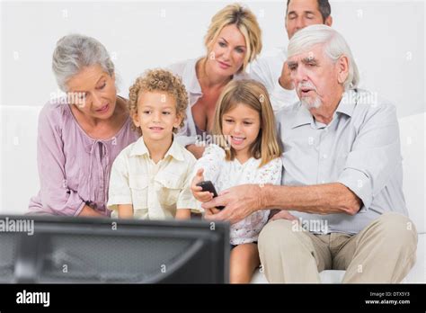 Family watching tv together Stock Photo - Alamy