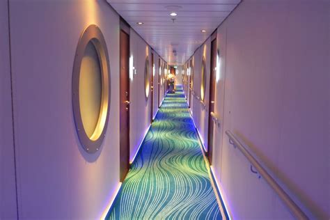 an airplane hallway is lit up with blue and green carpeting, along with ...