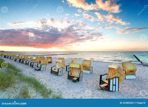 Beach chairs at sunset stock photo. Image of water, evening - 42380284