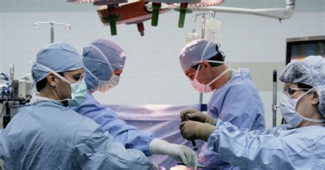 A group of doctors performing surgery in a hospital photo – Doctors and nurses Image on Unsplash