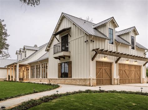 a large white house with wooden garage doors