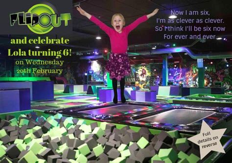 a woman standing on top of a green and black trampoline with her arms ...