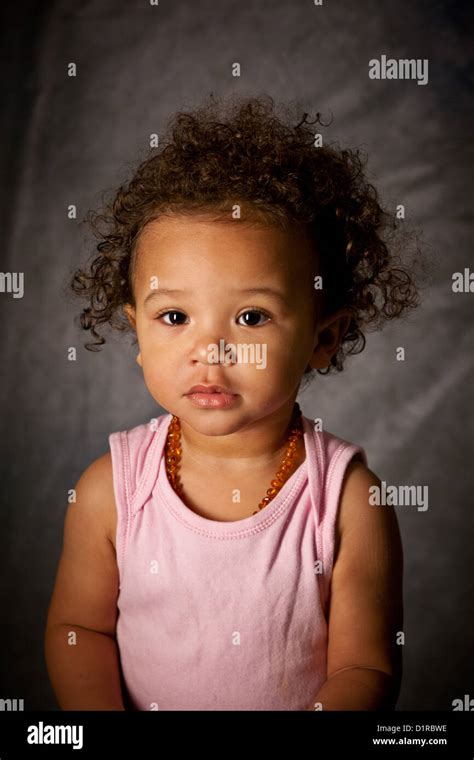 Studio portrait of a cute baby girl, 18 months, mixed race Stock Photo ...