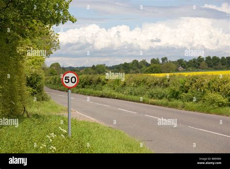 50 MPH speed limit sign on rural road Stock Photo - Alamy