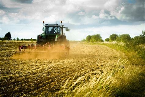 Tractor ploughs field Stock Photo by ©antb 21794943