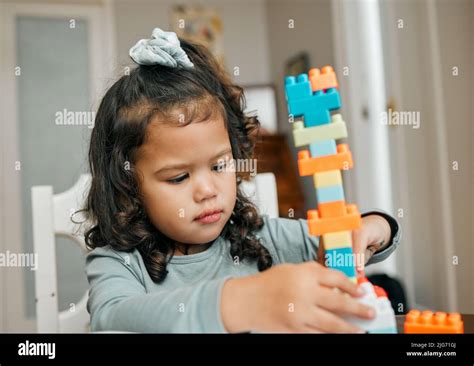 Really goos for hand and eye coordination. Shot of a cute little girl playing with building ...