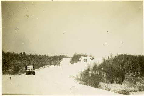 Three vehicles on snowy roadway through woods, Alaska c.1943. | The Digital Collections of the ...