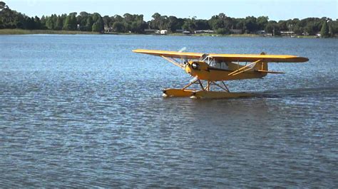 Landing And Taxi of a PJ3 Piper Cub Float Plane At Jack Brown's Seaplane Base - YouTube