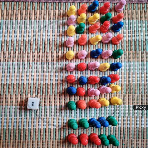 Image of Bunch Of Colorful Game Board Pieces Isolated On Mat-BD043627-Picxy