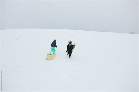 «Child Sledding On Hill In Snow» del colaborador de Stocksy «Maria ...