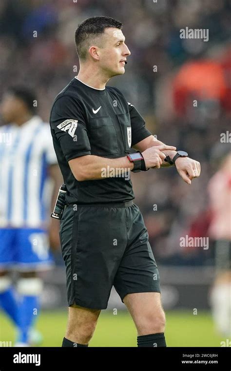 Referee Lewis Smith checks his watch during the Southampton FC v ...