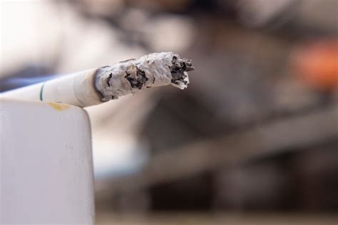 Premium Photo | Macro view of burning cigarette with smoke.