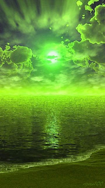 an image of a green sky over the ocean with clouds and sun reflecting ...