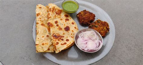 Hydrabadi Kabab Paratha with Green Chili Sauce & Onion on Transparent Plate. Stock Photo - Image ...