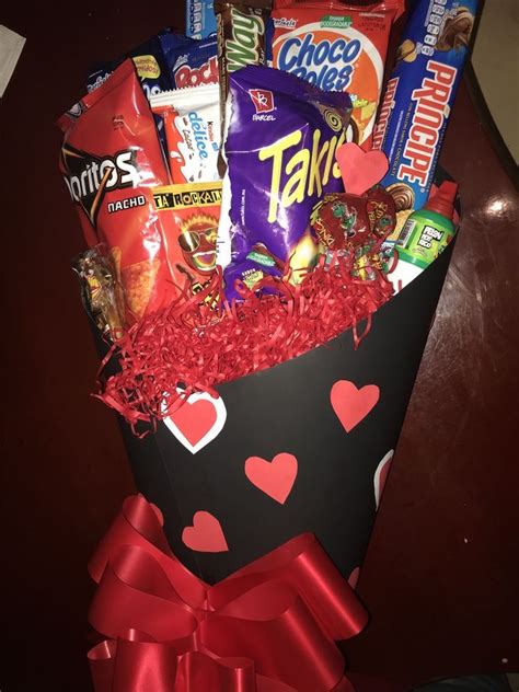 a valentine's day gift basket with candy, candies, and chocolates