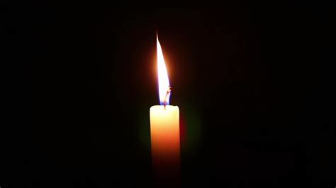 Candle flame against isolated black background 8704541 Stock Video at Vecteezy