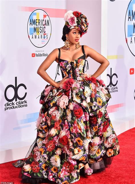 a woman in a floral dress on the red carpet at an american music awards ...