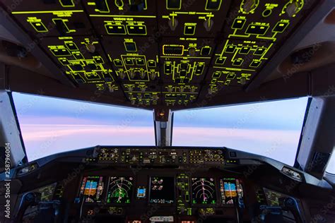 Beautiful twilight sunset sky at high altitude from airplane cockpit view. Inside cockpit can ...