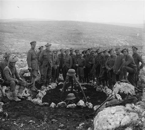British soldiers pose next to a mass grave for Ottoman soldiers killed during the Battle of Tel ...
